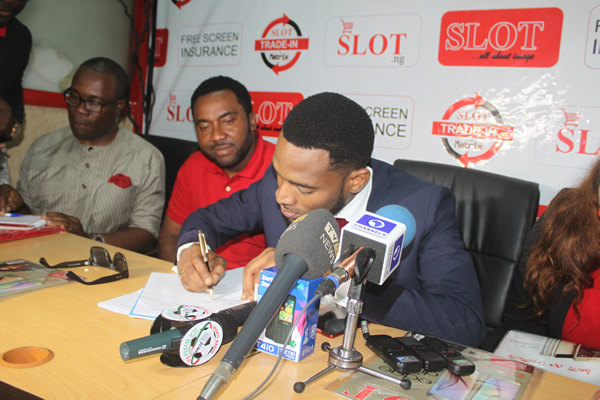 Dbanj signing his as SLOT ambassador